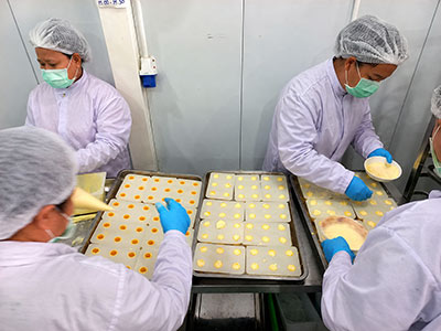 Chocolate molds being filled with gelato